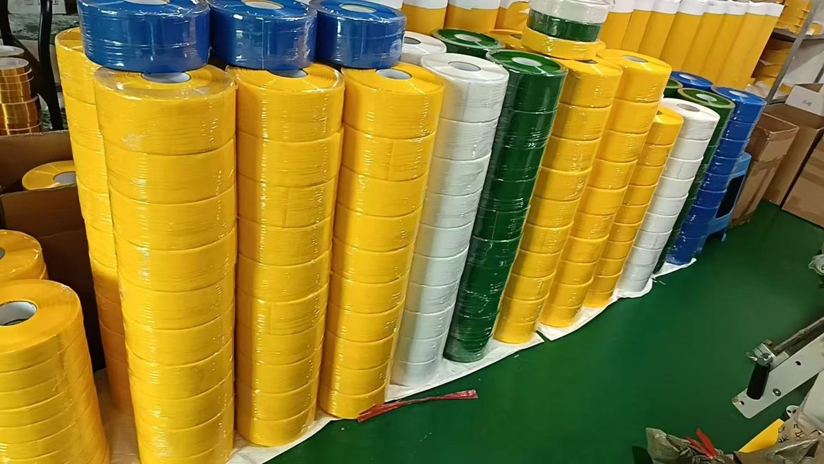 Heavy-duty PVC floor marking tape rolls in yellow, blue, green and white, shrink-wrapped on pallets for export at Songyang's Dongguan plant