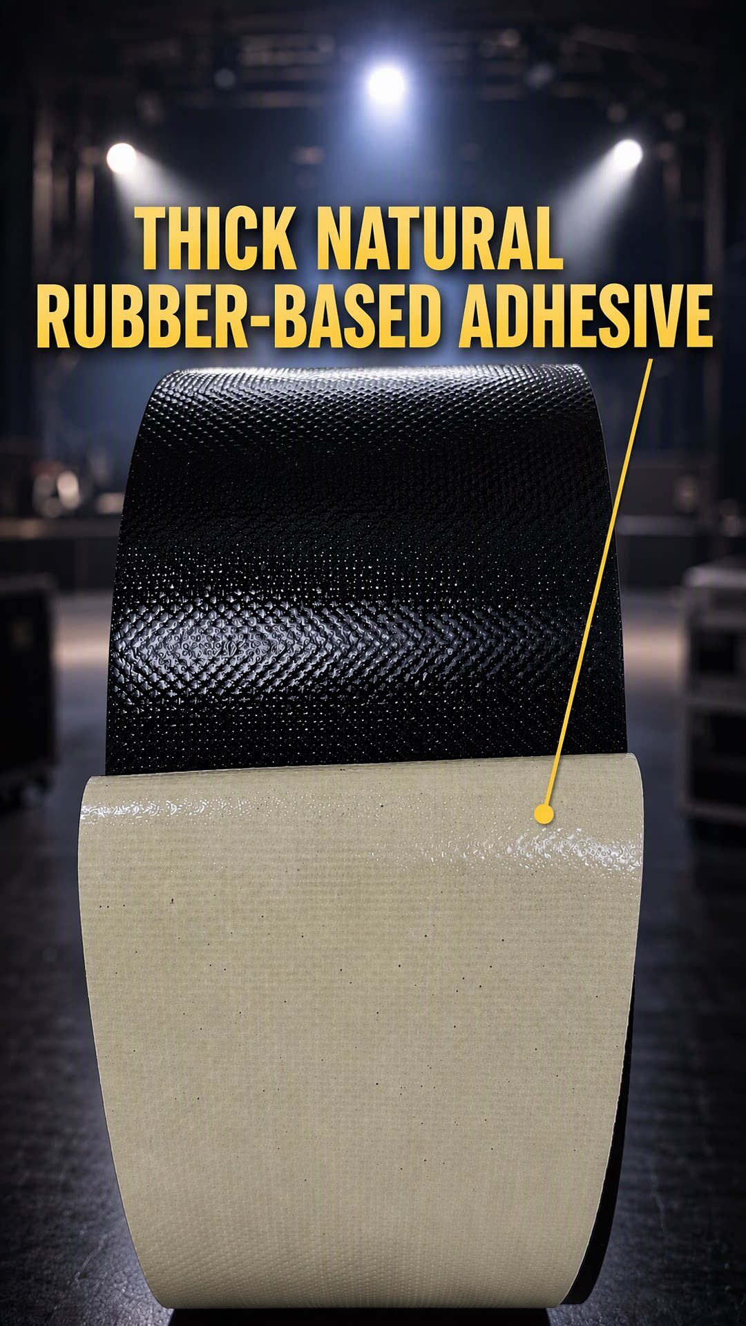 Unrolled black gaffer tape showing the natural rubber adhesive side and the coated cloth face